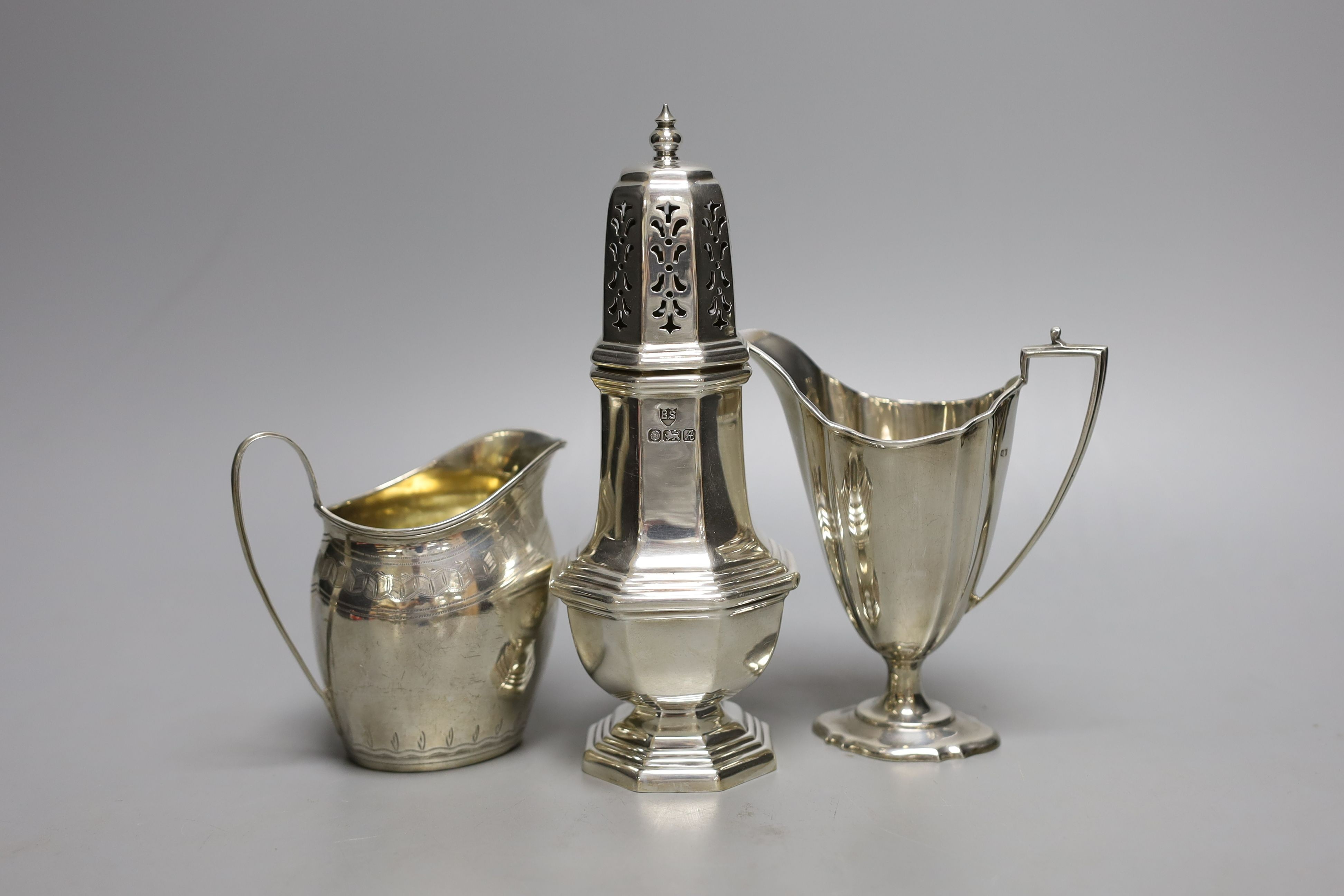 Two silver cream jugs including Victorian and a modern silver sugar caster, 11.5oz.